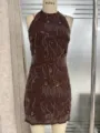 Detailed view of dark brown halter dress with intricate sequin and bead floral embroidery. - Brown