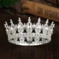 Close-up detail of a silver baroque tiara crown with sparkling crystal rhinestones. - Silver + White Waterdrop Rhinestone
