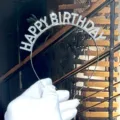 Detailed close-up view of shiny rhinestone birthday tiara headband featuring sparkling details. - Silver