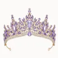 Detailed close-up of a sparkling gold tiara encrusted with purple and clear crystal rhinestones. - Gold with Purple Zircon