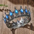 Close-up detail of the vintage baroque alloy crown featuring striking blue teardrop rhinestones. - Gun Black + Magic Blue Rhinestone