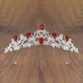 Detailed close-up of a silver tiara crown with red crystal rhinestones for girls performance. - Silver with Red Rhinestone