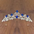 Detailed close-up of the elegant silver crystal tiara with deep blue rhinestones. - Silver Blue