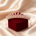 Detailed shot of a luxury bridal rhinestone tiara crown with pink crystals, perfect for wedding. - KC Gold-Pink