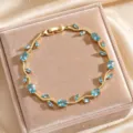 Gold-tone vine leaf bracelet sparkling blue zircon elegant jewelry delicate design accessory - Lake Blue