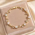 Gold leaf vine bracelet featuring sparkling cubic zirconia stones in exquisite detail design. - Clear