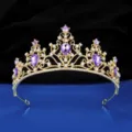 Detailed close-up of a gold bridal tiara crown with purple crystal stones and sparkling rhinestones. - Gold + Purple Rhinestone