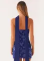 Back view of elegant royal blue sequined bodycon mini dress with long decorative sashes - Navy Blue Neck Gaiter Style
