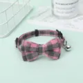 Detailed close-up of pink plaid adjustable pet bow tie collar with a tiny silver bell - Rose Red
