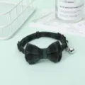 Detail view of green plaid adjustable pet collar with a large bowtie and silver bell. - Dark Green