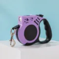 Purple retractable dog leash with LED light and bone patterns on a blue background. - Battery Powered / Purple