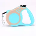 Retractable pet leash in light blue and tan with ergonomic handle and metal clip - Bone Beige Light Blue