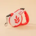 Durable red and white automatic retractable dog leash featuring a minimalist leaf pattern design - Leaf Red