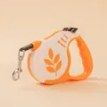Durable orange and white retractable dog leash with ergonomic handle and secure metal clasp - Leaf Orange