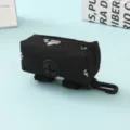 Durable black portable dog poop bag dispenser featuring white paw prints and a plastic clip - Black Paw Prints