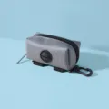 Grey portable dog waste bag dispenser with black hanging clip and cross-opening - 10x5cm / Gray