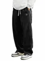 Detailed view of men's loose black corduroy casual pants with adjustable drawstring - S / Bottoms / Black