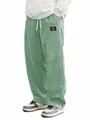 Detail showing the textured sage green corduroy fabric and loose fit of men's casual pants. - S / Bottoms / Khaki