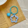 Detail of blue bell and lavender acrylic star pendant on a light blue keychain ring - Blue Star Keychain