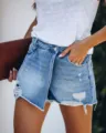 Close-up view of women's summer casual distressed denim skort with ripped details - S / Light Blue
