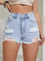 Macro close-up view of light wash distressed denim shorts with frayed hems and ripped detailing - XS(26) / Bottoms / Light Wash Blue