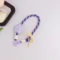 Handgemachte geflochtene Handykette mit lila Stern und gelber Schleife, süßer Taschenanhänger. - Lila