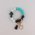 Stylisches Silikon Perlen Armband als Schlüsselanhänger mit Kreuz Anhänger und schwarzer Quaste. - Türkis