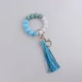 Silicone and wooden beaded keychain wristlet featuring a blue tassel variant style. - Blue