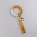 Silicone bead keychain bracelet with checkerboard wood beads and yellow tassel pendant. - Yellow