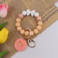 Silicone beaded wristlet keychain with cute bow design and handmade pendant for women daily use. - Pink