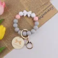 Silicone bead keychain bracelet with cute bow design, perfect handmade gift for women. - Natural