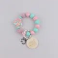 Silicone beaded keyring bracelet with rainbow charm and handmade wooden tag for women. - Rainbow