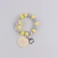 Yellow grey silicone beaded bracelet keychain with cute notebook charm and handmade pendant. - Book and Pencil