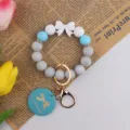 Silicone bead wristlet keychain with bow grey blue beads and handmade pendant variant - Blue