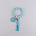 Bracelet porte-clés en perles de silicone avec gland en cuir bleu et pendentif en bois. - Bleu