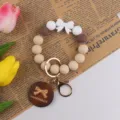 Silicone bead keychain bracelet with cute bow pendant and wooden handmade gift tag variant. - Dark Coffee