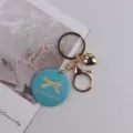 Schicker handgemachter blauer Schlüsselanhänger mit goldener Metallkette und Herzetui. - Schleife Blau
