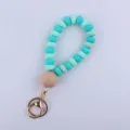 Silicone flat bead and wood bead keychain wristlet detail view, portable keyring accessory. - Green