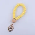 Yellow silicone beaded wristlet keychain with natural wooden bead and metal keyring. - Yellow