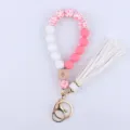 Silicone beaded wristlet keychain with evil eye wood bead, tassel and gold hardware. - Petal