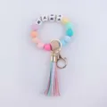 Detailed close-up view of the colorful silicone bead keychain with letter beads and a cute tassel. - Colorful