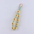 Close-up detail of the handmade macrame daisy keychain, showing delicate woven petal texture. - Yellow