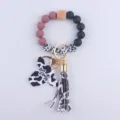 Silicone bead keychain with cow print, wooden bead, cow head pendant and tassel charm. - Dark Bean Paste