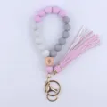 Silicone beaded wristlet keychain with wooden eye charm and leather tassel for keys. - Light Purple