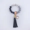 Stylish silicone bead keychain bracelet for women featuring black tassel and letter charms. - Black