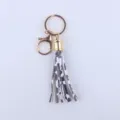 Kuhmuster Leder Quaste Schlüsselanhänger mit goldener Hardware 8cm Länge Akzessoire - Kuh
