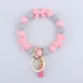 Bracciale portachiavi in perline di silicone con fiocchi graziosi e nappina in metallo donna. - Rosa