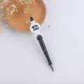 Closeup detail of the DIY beaded ballpoint pen featuring bear design and sleek black body. - Bear