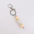 Silicone bead keychain with sparkling rhinestone ball and metal ring for bag charm accessory. - Yellow