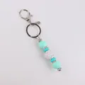 Mint green silicone bead keychain with sparkly rhinestone disco ball and silver keyring accessory. - Green